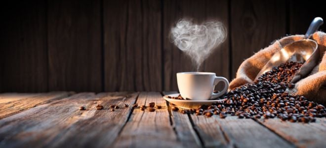 Kaffeetasse dampf herz neben kaffeebohnen